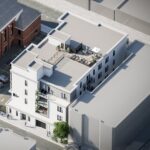 Aerial view of a rendering of modern looking white apartment building.