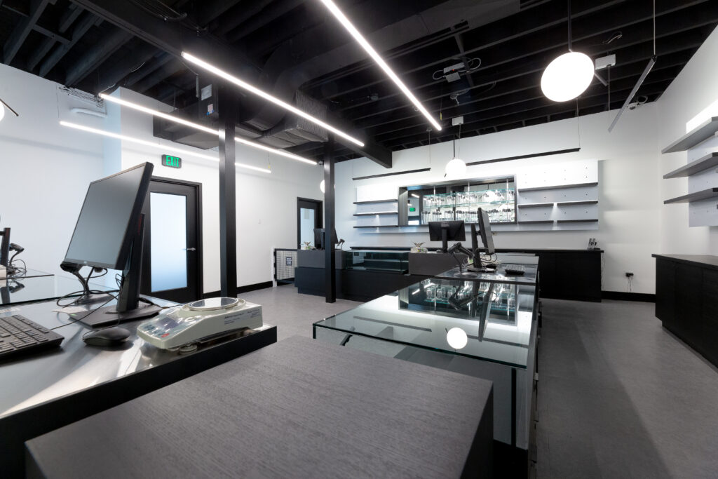 Cannabis retail area with glass cases and a register.