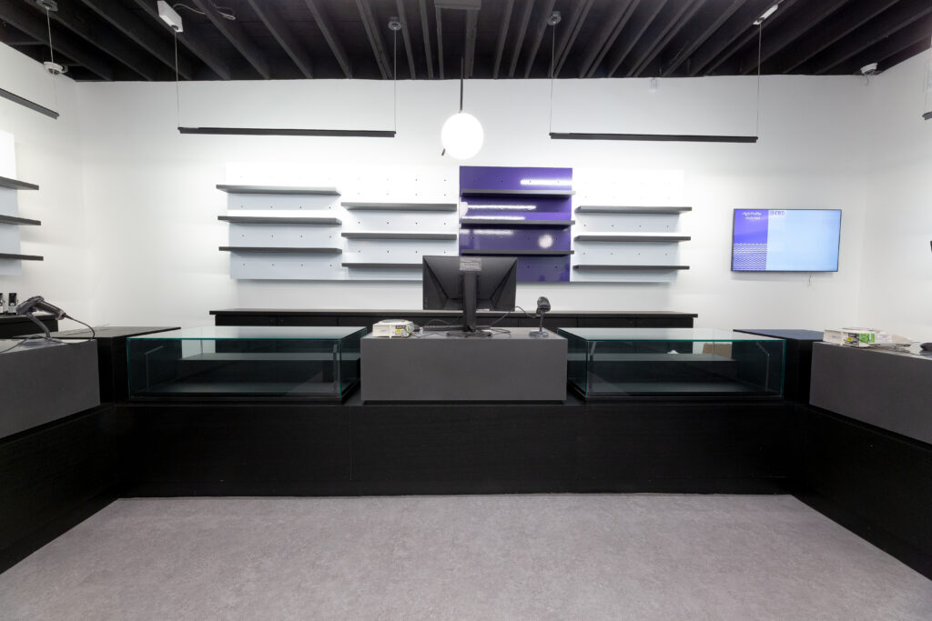 Cannabis retail area with glass cases and a register.